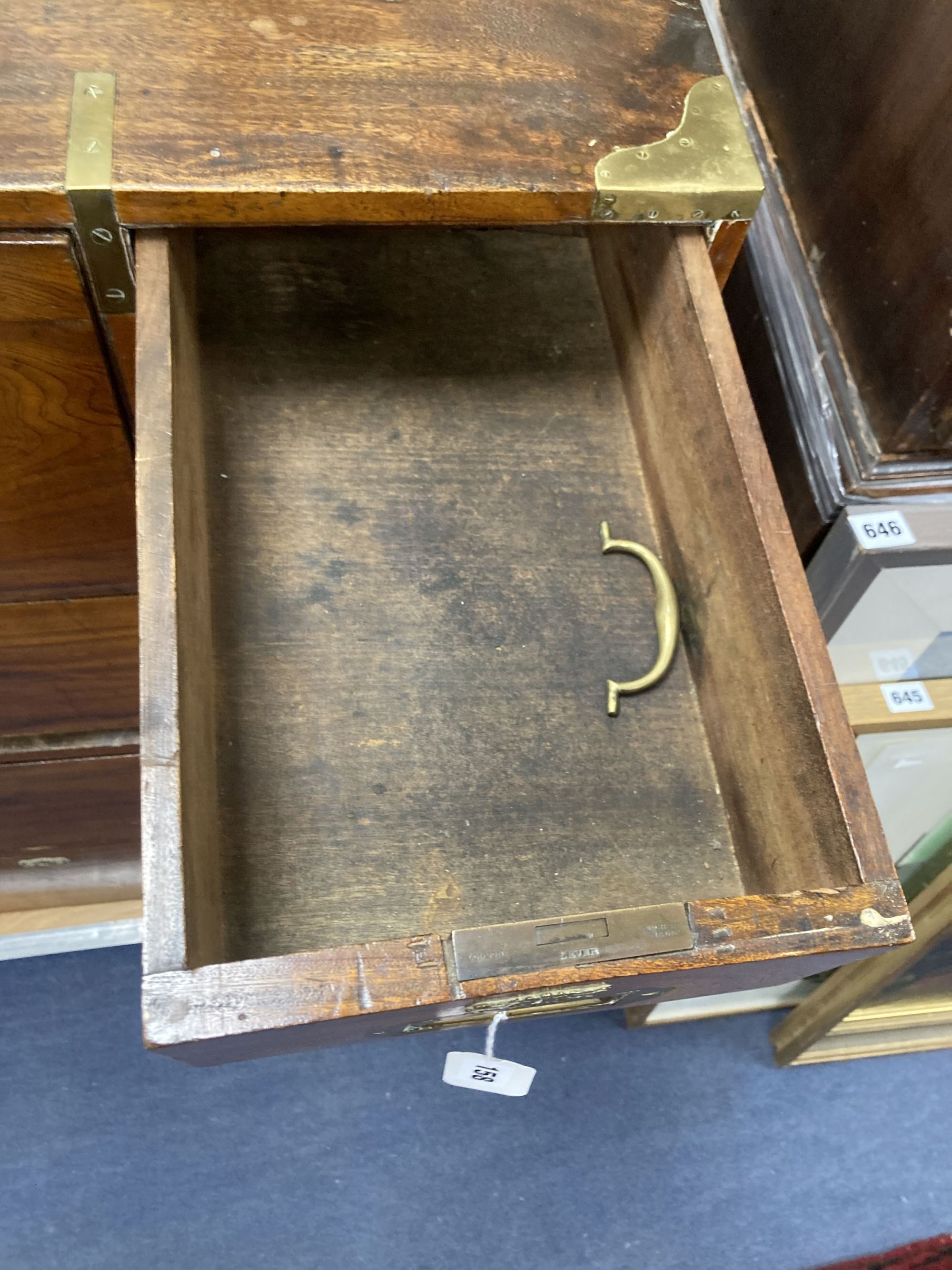 A 19th century brass mounted teak two part military chest (lacking one drawer) width 97cm, depth 46cm, height 107cm